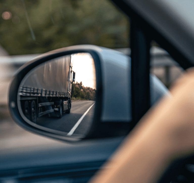 En la imagen se muestra un camión en un retrovisor